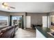Bright living room with a ceiling fan, private balcony, and hardwood floors near dining area at 2428 W 82Nd Pl # 2D, Westminster, CO 80031