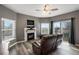 Cozy living room with a fireplace, TV, ceiling fan, and access to a private balcony with views at 2428 W 82Nd Pl # 2D, Westminster, CO 80031