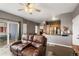 Comfortable living room area with a ceiling fan, private balcony, and kitchen access at 2428 W 82Nd Pl # 2D, Westminster, CO 80031