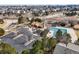 Aerial view of community pool and parking lot next to several houses and roads at 743 Briar Haven Dr, Castle Pines, CO 80108