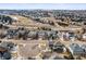 Stunning aerial view of a neighborhood with diverse home styles, mature trees, and community green spaces at 743 Briar Haven Dr, Castle Pines, CO 80108