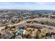 Aerial view of community pool and parking lot next to several houses and a field at 743 Briar Haven Dr, Castle Pines, CO 80108