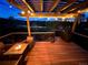 Inviting back deck with a gas grill and a fire pit table with string lights, perfect for outdoor entertaining and relaxation at 743 Briar Haven Dr, Castle Pines, CO 80108
