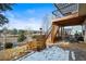 Two level deck featuring metal railings and wooden stairs overlooking a spacious backyard and nearby scenery at 743 Briar Haven Dr, Castle Pines, CO 80108