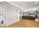 Finished basement features recessed lighting, modern flooring, media area with TV and full bathroom access at 743 Briar Haven Dr, Castle Pines, CO 80108