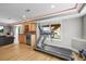 Finished basement featuring modern exercise equipment, wet bar, and entertainment area with light wood flooring at 743 Briar Haven Dr, Castle Pines, CO 80108