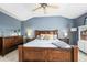 Spacious bedroom featuring a large bed, matching nightstands, a dresser, a ceiling fan, and plush carpet for cozy comfort at 743 Briar Haven Dr, Castle Pines, CO 80108