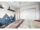 Bedroom featuring a desk area, a bed, decoratively painted walls, and closet at 743 Briar Haven Dr, Castle Pines, CO 80108
