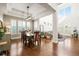 Elegant dining room featuring hardwood floors, a large window, and an open concept to the living room at 743 Briar Haven Dr, Castle Pines, CO 80108