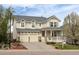 Charming two-story home featuring a covered porch, well-kept lawn, and a two car garage at 743 Briar Haven Dr, Castle Pines, CO 80108