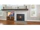 Close up of the fireplace with marble surround, wood mantel, and built-in shelving at 743 Briar Haven Dr, Castle Pines, CO 80108
