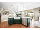 Bright kitchen with large island, farmhouse sink, modern appliances, and hardwood floors at 743 Briar Haven Dr, Castle Pines, CO 80108