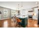 Modern kitchen featuring a large island with seating, stainless steel appliances, and a bright breakfast nook at 743 Briar Haven Dr, Castle Pines, CO 80108