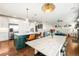 Open-concept kitchen with a center island and seamless flow to the living area at 743 Briar Haven Dr, Castle Pines, CO 80108