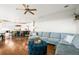 Open living room featuring hardwood floors, plush seating, and an open-concept kitchen at 743 Briar Haven Dr, Castle Pines, CO 80108
