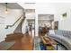 Spacious open-concept living area with hardwood floors, staircase, and seamless flow to the dining area at 743 Briar Haven Dr, Castle Pines, CO 80108