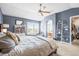 View of a bedroom with large windows, ensuite bathroom access, walk-in closet and carpeted floors at 743 Briar Haven Dr, Castle Pines, CO 80108