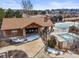Community clubhouse with pools, landscaping, brick features, and sidewalks offering leisure and recreation at 743 Briar Haven Dr, Castle Pines, CO 80108