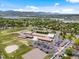 Scenic aerial view of school complex and surrounding neighborhoods with parks, sports fields, and a lake backdrop at 3030 Alkire St, Golden, CO 80401