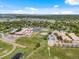 Expansive aerial view of school buildings with athletic fields, parking lots, and surrounding neighborhood with trees at 3030 Alkire St, Golden, CO 80401