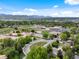 Scenic aerial view of school complex and surrounding neighborhoods with parks, sports fields, and a lake backdrop at 3030 Alkire St, Golden, CO 80401