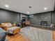 Finished basement area with stone fireplace, hardwood floors, and desk area at 3030 Alkire St, Golden, CO 80401
