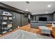 Spacious finished basement with modern decor, hardwood floors, and comfortable seating area at 3030 Alkire St, Golden, CO 80401