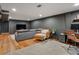 Finished basement featuring hardwood floors, a gray couch, and a comfortable lounge area at 3030 Alkire St, Golden, CO 80401