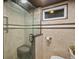 Tiled shower featuring a glass enclosure and seat at 3030 Alkire St, Golden, CO 80401