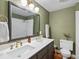 Stylish bathroom with double sinks, modern fixtures, and a shower with white tile at 3030 Alkire St, Golden, CO 80401