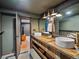 Rustic bathroom with double sinks, wooden vanity, and modern fixtures at 3030 Alkire St, Golden, CO 80401