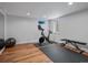 Bright exercise room with wood floors, exercise bike, weights, and natural light, ready for your workout routine at 3030 Alkire St, Golden, CO 80401