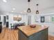 Bright kitchen features a wood top island, stylish pendant lights, and a dining area at 3030 Alkire St, Golden, CO 80401