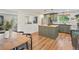 Open kitchen with a spacious island and hardwood floors extending to dining area at 3030 Alkire St, Golden, CO 80401