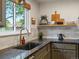 The kitchen boasts granite counters, stainless steel sink and modern backsplash tiles at 3030 Alkire St, Golden, CO 80401