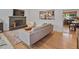 Bright living room with a stone fireplace, hardwood floors, and a view to the kitchen at 3030 Alkire St, Golden, CO 80401