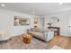 Open living room with hardwood floors and a view of the adjacent kitchen with a breakfast bar at 3030 Alkire St, Golden, CO 80401
