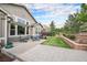 Spacious backyard with a patio, lush lawn, and well-maintained landscaping at 13942 W 87Th Dr, Arvada, CO 80005