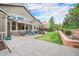 An outdoor patio with seating and a landscaped backyard at 13942 W 87Th Dr, Arvada, CO 80005