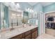Modern bathroom with double sinks, granite countertops, and a walk-in shower at 13942 W 87Th Dr, Arvada, CO 80005