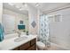 Clean bathroom featuring a white vanity, updated fixtures, and a shower-tub combination at 13942 W 87Th Dr, Arvada, CO 80005