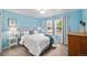 Cozy bedroom with natural light, blue accent wall, and comfortable furnishings at 13942 W 87Th Dr, Arvada, CO 80005