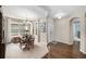 Formal dining room with a chandelier, hardwood floors, and large windows providing natural light at 13942 W 87Th Dr, Arvada, CO 80005