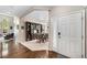 Elegant entryway with hardwood floors, a dining room view, and a front door at 13942 W 87Th Dr, Arvada, CO 80005
