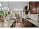 A bright kitchen featuring granite countertops, stainless steel appliances, and hardwood flooring at 13942 W 87Th Dr, Arvada, CO 80005