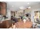 Modern kitchen with stainless steel appliances, a central island, and an open view into the living area at 13942 W 87Th Dr, Arvada, CO 80005