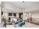 Open-concept living space with hardwood floors, views of the dining room, and a staircase at 13942 W 87Th Dr, Arvada, CO 80005
