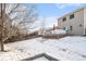 Large backyard with snowy landscape, deck, and plenty of space at 7190 Pine Hills Way, Littleton, CO 80125