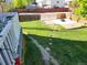 Large backyard with grassy area, patio, and walkway at 7190 Pine Hills Way, Littleton, CO 80125