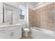 A bright bathroom with a shower-over-tub and tile flooring at 16517 W 92Nd Pl, Arvada, CO 80007